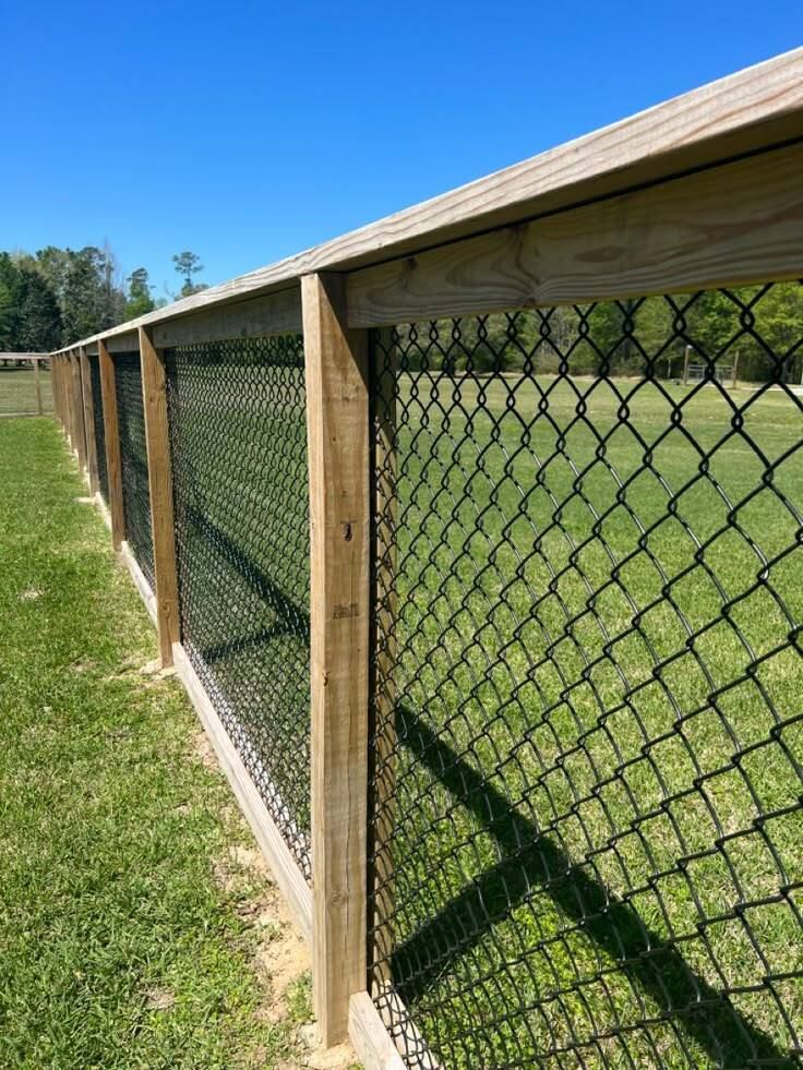 Chain-link fence with wood frame enclosure