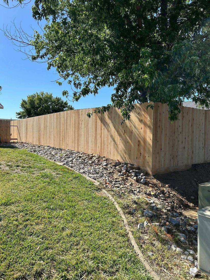 New cedar privacy fence along a green backyard lawn in Corpus Christi